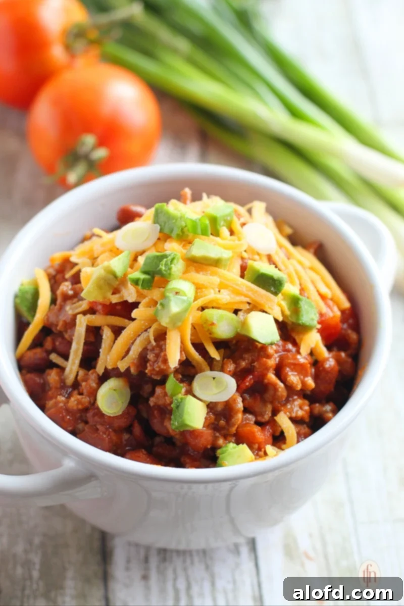 Hearty Skillet Chili 7 Serving of ground beef and kidney bean stew in a white bowl.