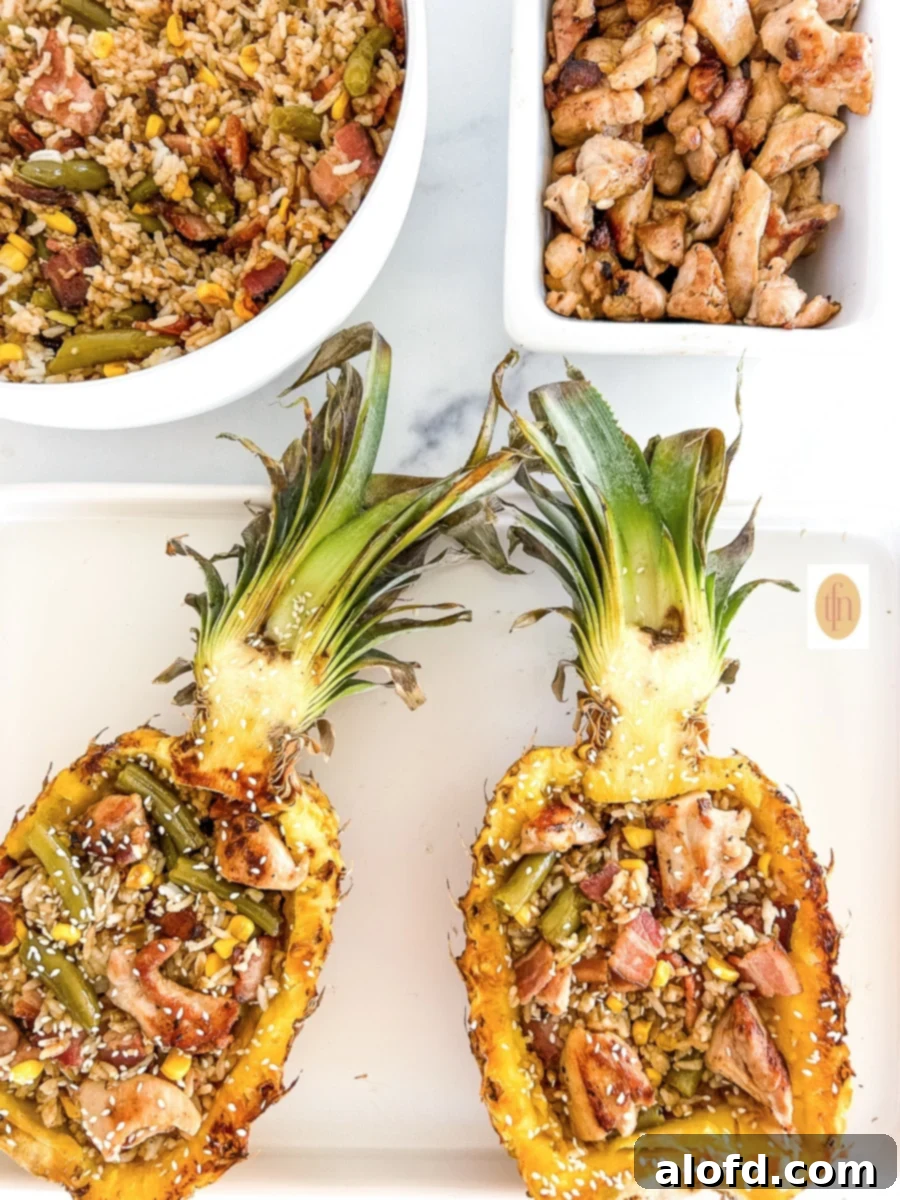 Hawaiian teriyaki chicken and pineapple fried rice served in a carved pineapple bowl, showcasing a sweet and savory tropical meal.
