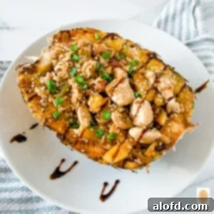 Hawaiian chicken and fried rice in a pineapple bowl.