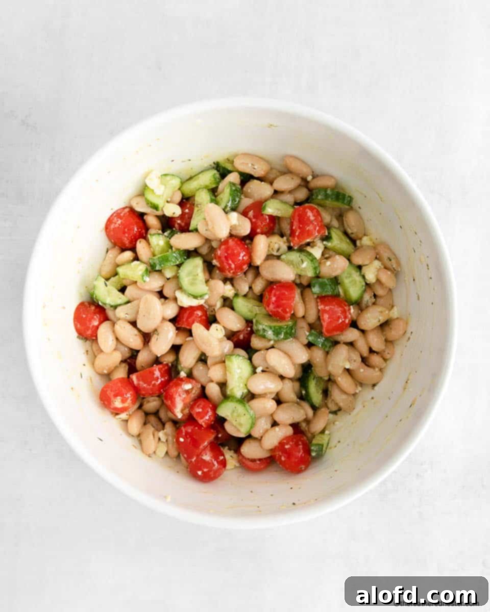 Vibrant Italian Bean Medley 8 A large bowl of white bean salad, beautifully tossed in creamy vinaigrette dressing and ready to serve.