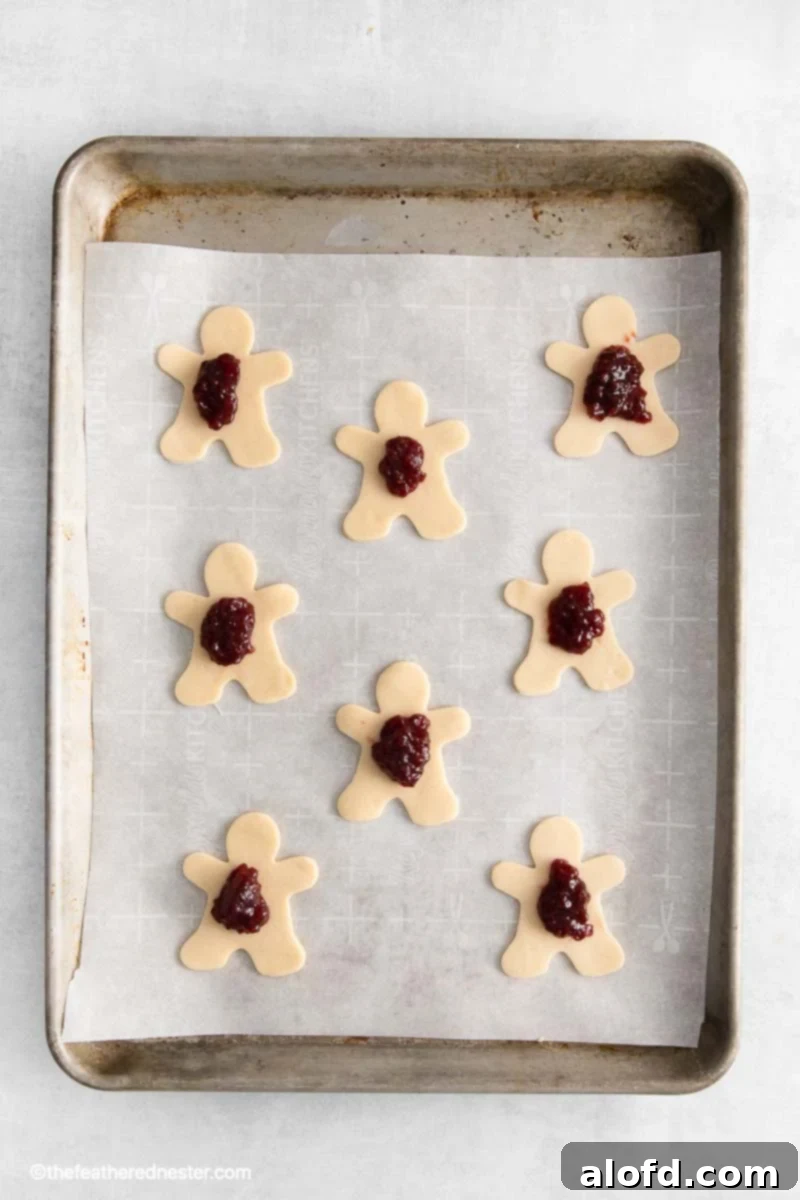 pastry cut out mummy pies on a parchment lined baking sheet