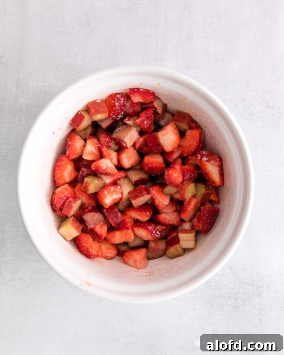 Chopped strawberries and apples mixed in a ramekin, ready for the topping.