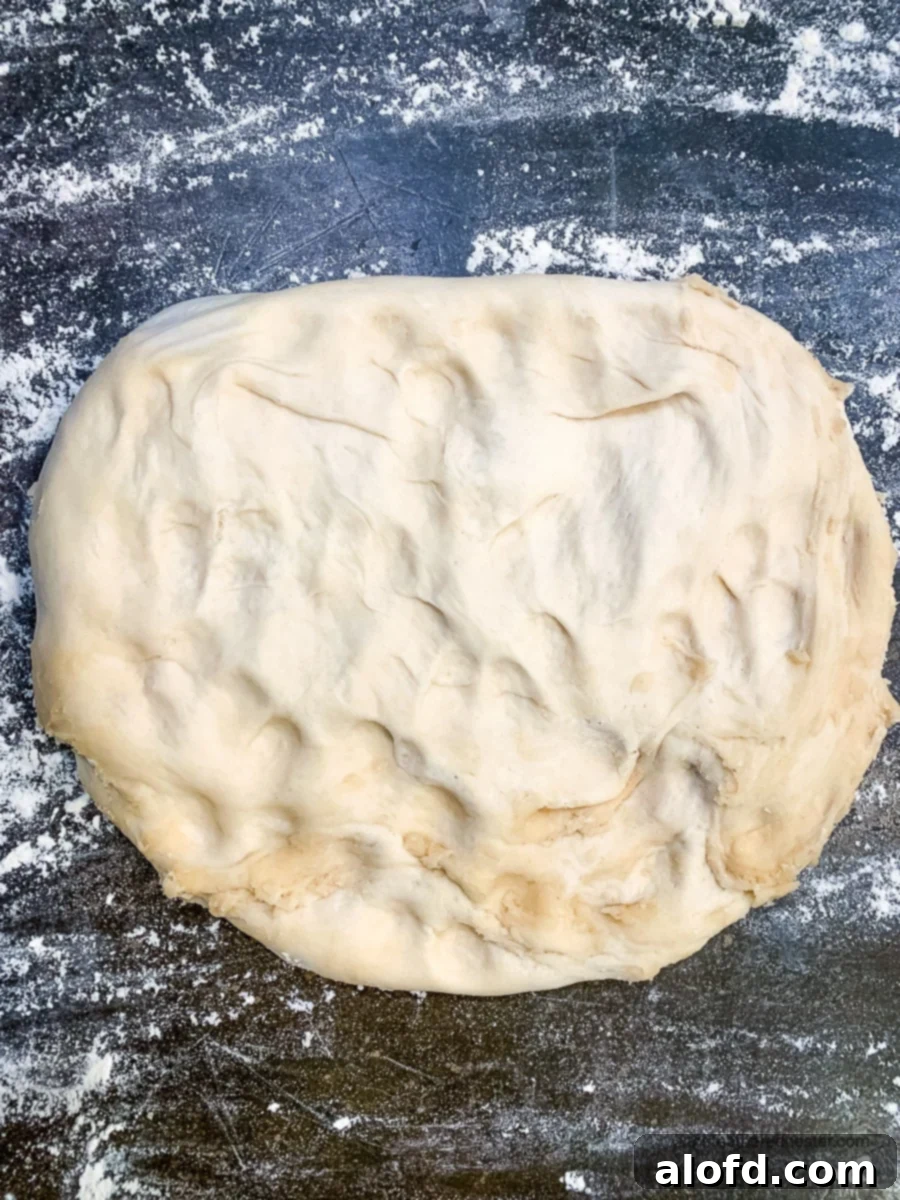 Rustic Sourdough Buns 5 Sourdough rolls dough mixture on a floured countertop.