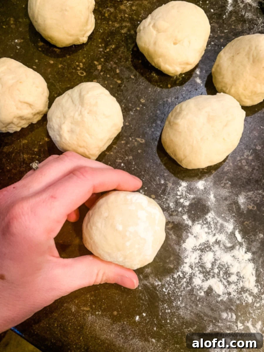 Rustic Sourdough Buns 9 Rolling the dough into balls using by hand.