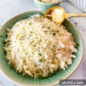 A large green bowl of Instant Pot Jasmine Rice with a gold serving spoon on top, showcasing its fluffy texture.