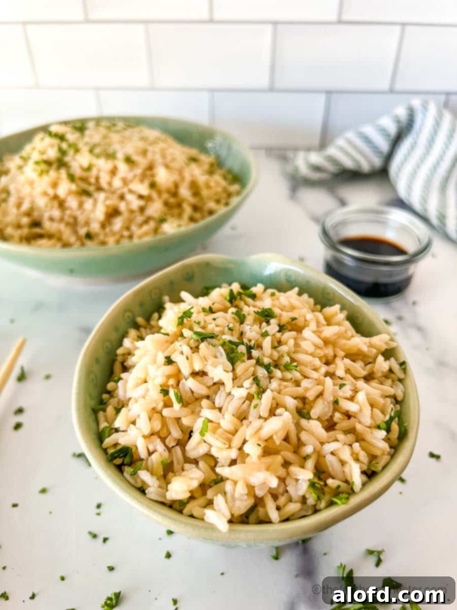 Fluffy Instant Pot Brown Basmati Rice 7 Healthy cooked brown basmati grains artfully arranged in two vibrant green serving bowls, ready for a nutritious meal.