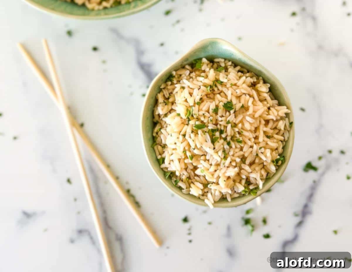 Fluffy Instant Pot Brown Basmati Rice 8 Chopsticks resting next to a bowl of fluffy brown basmati rice, garnished with fresh chopped cilantro, ready to be enjoyed.