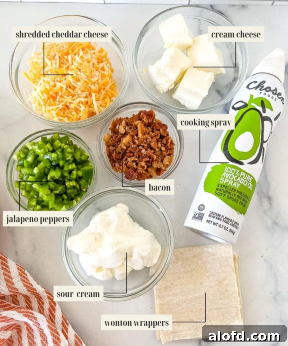 Labeled ingredient image for jalapeno popper wonton cup recipe, showing cream cheese, cheddar, bacon, sour cream, and jalapeños.