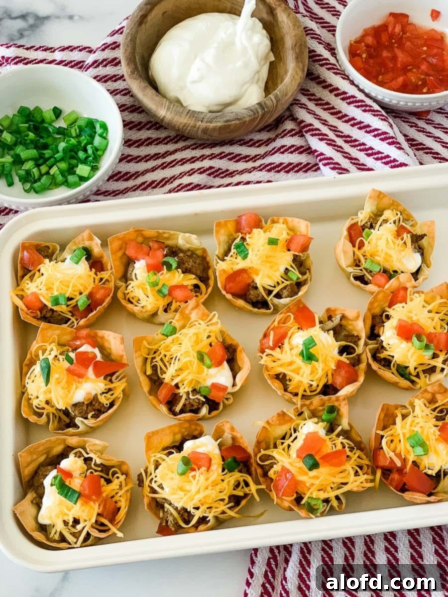 Crispy Baked Wonton Delights 2 A white tray filled with colorful wonton cups appetizers, perhaps Taco Wonton Cups.
