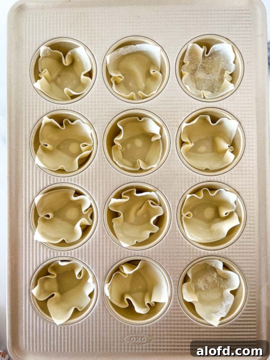 Crispy Taco Wonton Bites 6 A muffin pan filled with perfectly golden and crispy wonton cups, ready to be filled with delicious ingredients.