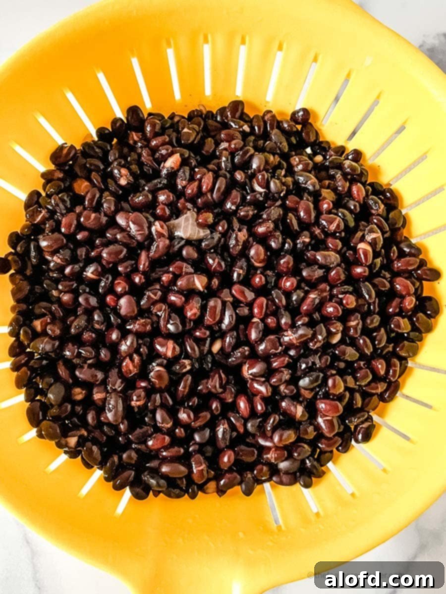 Easy Instant Pot Black Beans 7 Rinsing black beans in a colander.