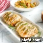 Our Top 5 Thanksgiving Dinner Recipes 6 A serving plate featuring perfectly roasted turkey tenderloins, accompanied by a striped cloth and a side of golden-brown roasted potatoes.