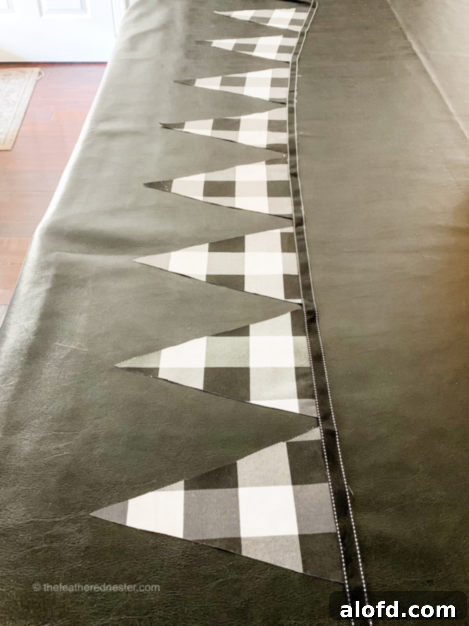 DIY pennant garland for the holidays displayed on a black table.