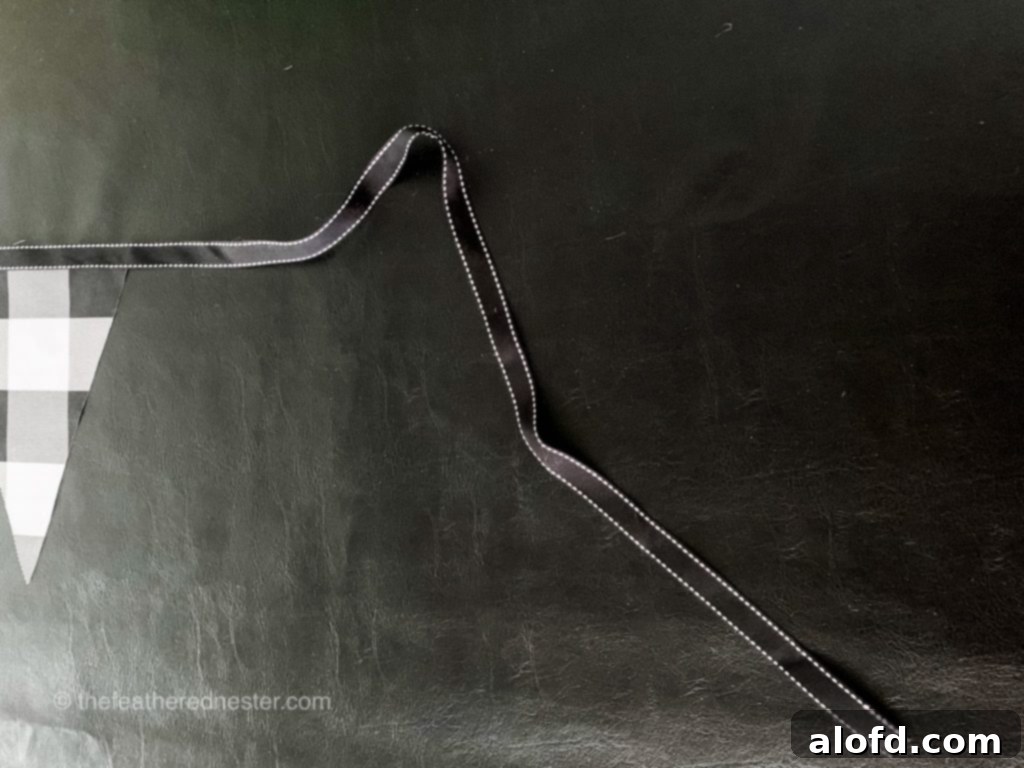 Black ribbon unrolled on a table, illustrating measurement preparation.