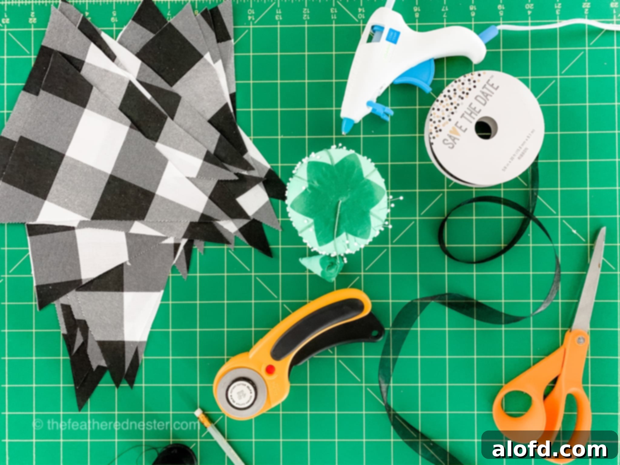 Crafting tools on a green board, prepared for making a fabric garland.