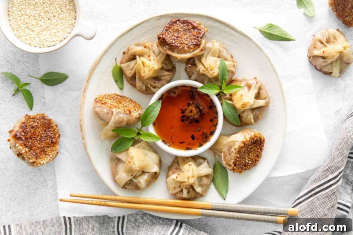 Umami Mushroom Pockets 15 A horizontal close-up photograph of delicious mushroom dumplings beautifully presented on a white plate, with elegant chopsticks resting alongside and a small bowl of vibrant garlic chili oil placed invitingly in the center.