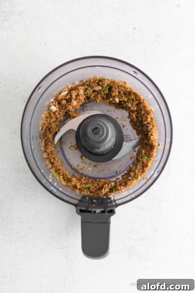 Umami Mushroom Pockets 8 The mushroom dumpling ingredients, now blended with added soy sauce and panko breadcrumbs, are visible inside the food processor, forming a cohesive filling.