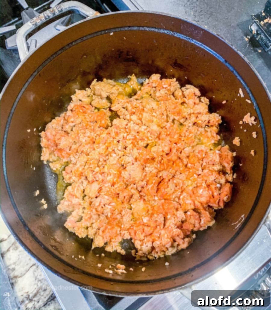 Rustic Tuscan Sausage and Kale Soup 3 Browning Italian sausage in a cast iron Dutch oven for Zuppa Toscana soup.