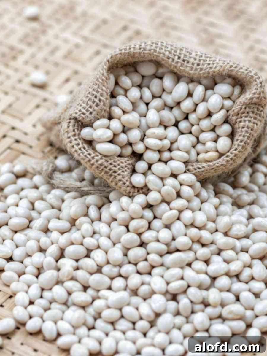 Beyond the Can: 3 Smart Ways to Cook Dried Beans 3 Dried navy beans spilling out of an open burlap sack.