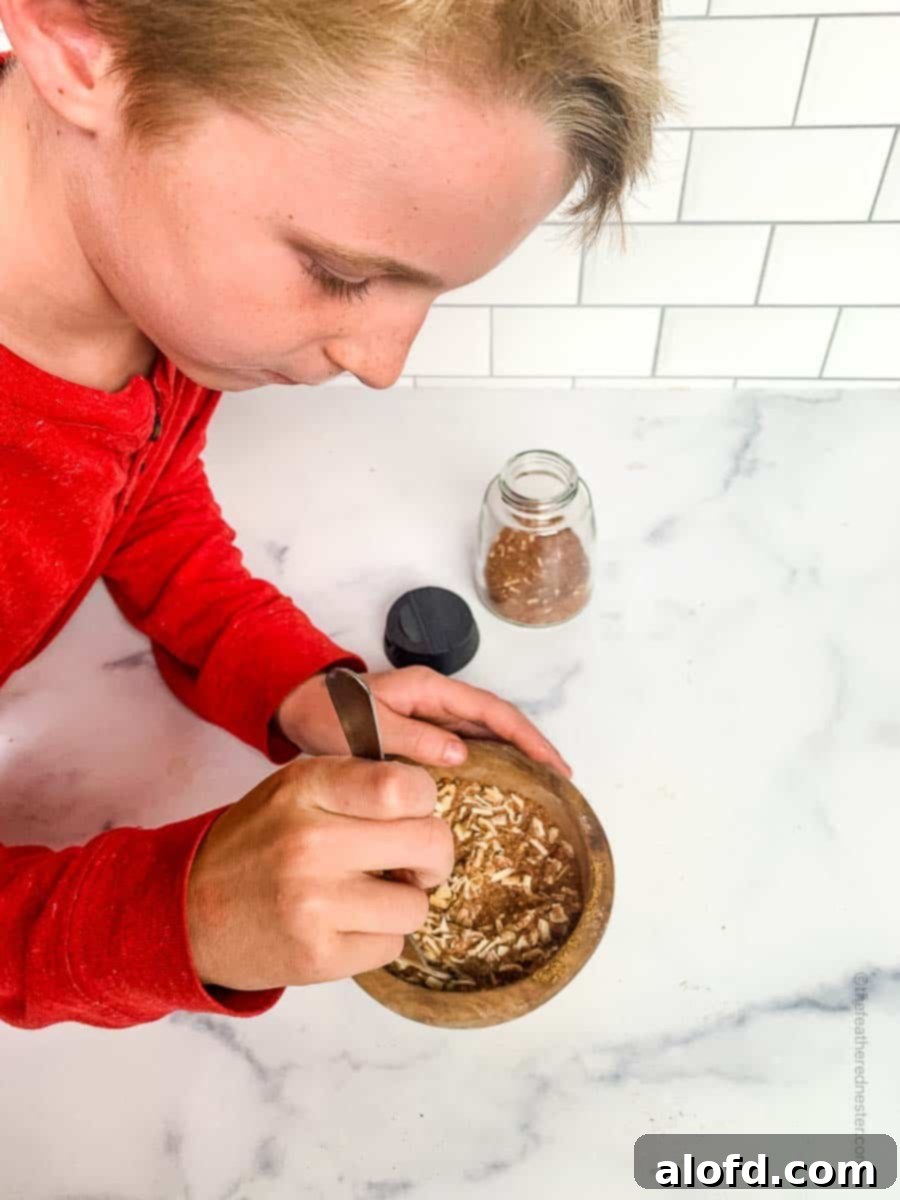 Ultimate Chicken Taco Mix 6 A boy in red shirt mixing the spices in a wooden bowl.