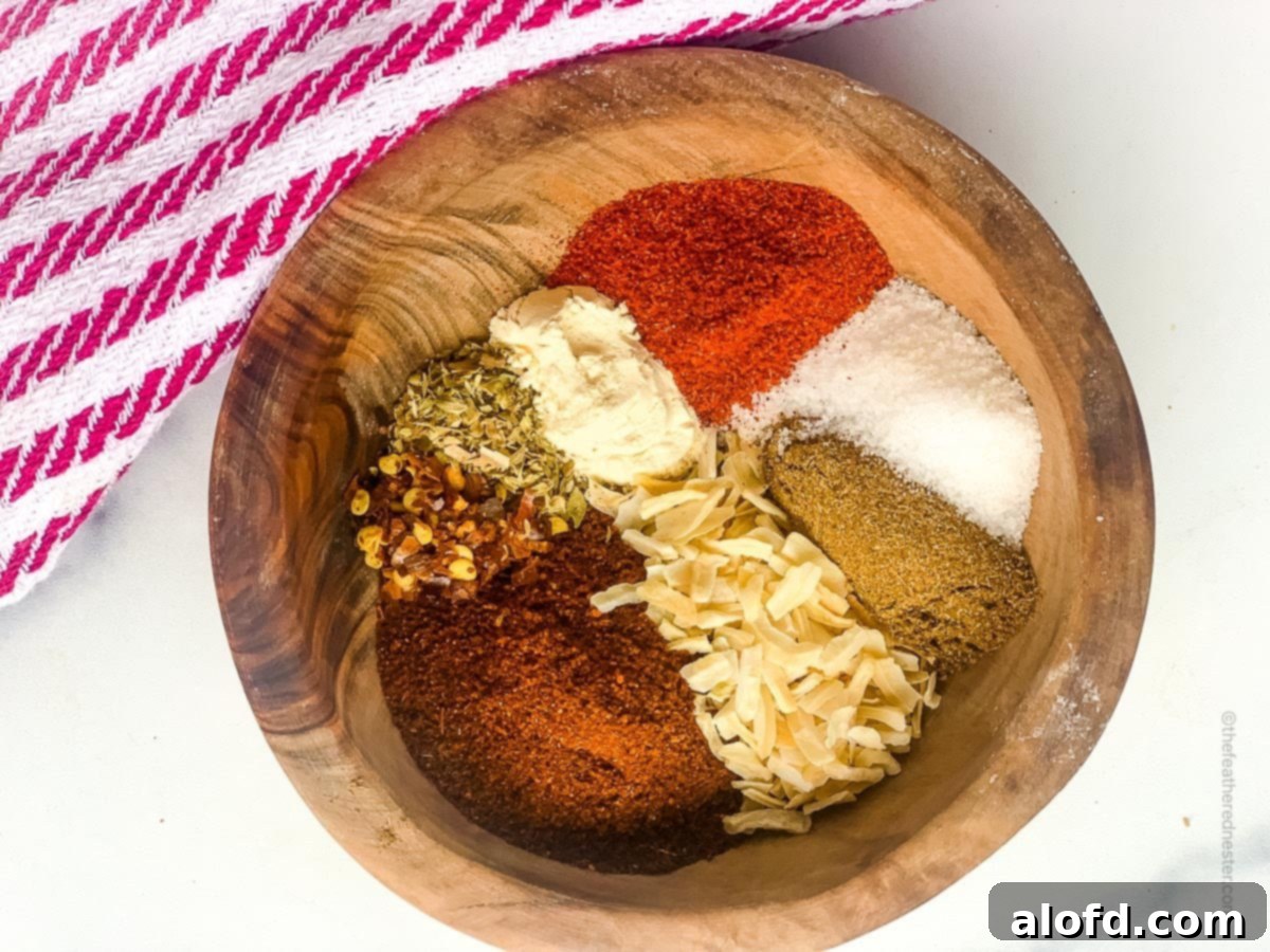 Ultimate Chicken Taco Mix 8 Homemade chicken taco spices ingredients all placed in a wooden bowl.