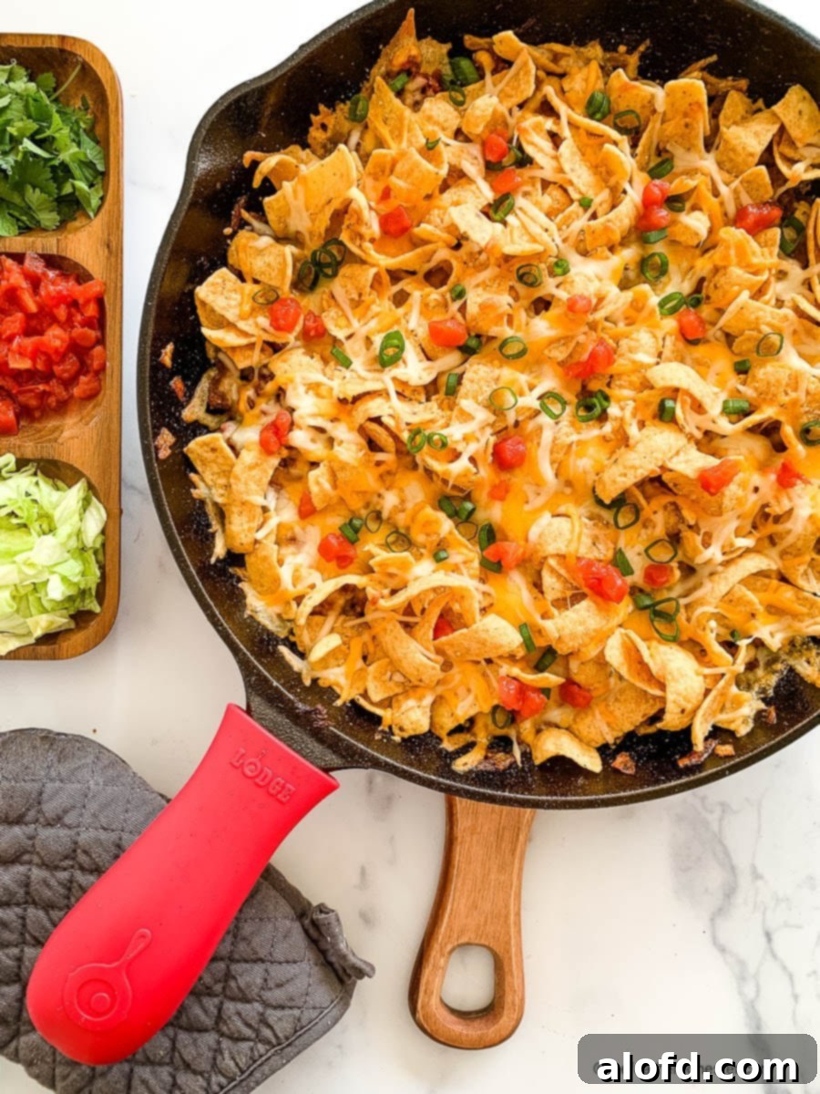 Loaded Taco Bake 2 A vibrant baked walking taco casserole generously topped with golden corn chips, ready to serve.