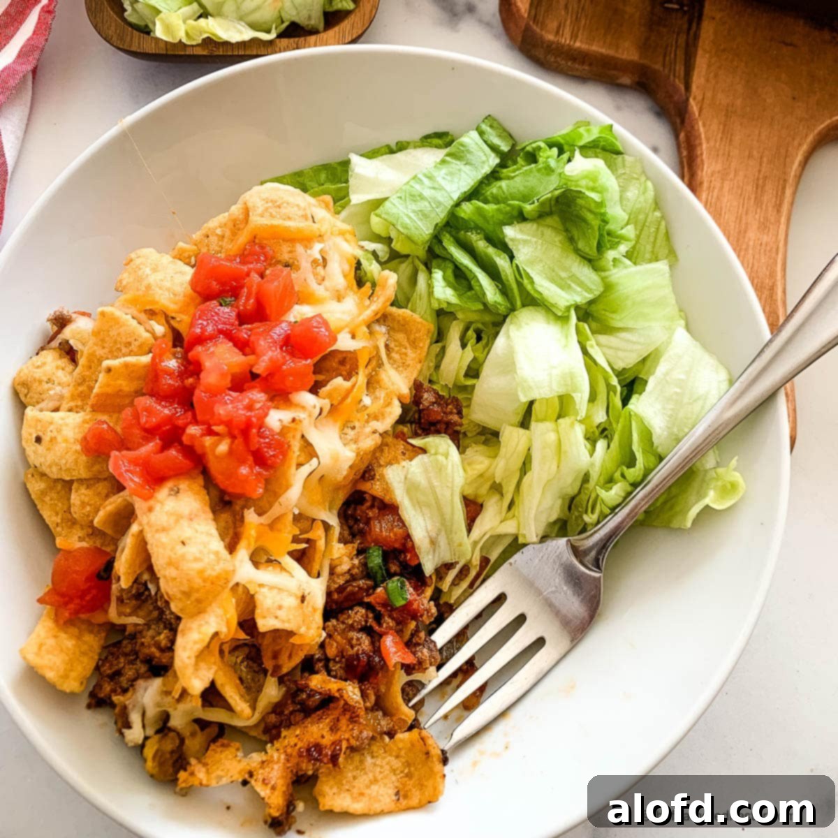 Loaded Taco Bake 3 A close-up of a plate filled with delicious taco casserole featuring Fritos, showcasing its crunchy topping and cheesy interior.