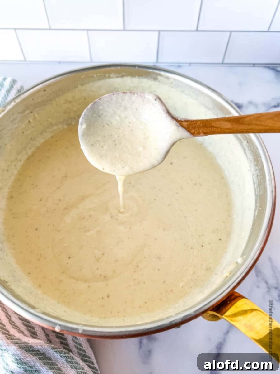 Velvety Cheese Béchamel 3 A pot of bechamel cheese sauce.