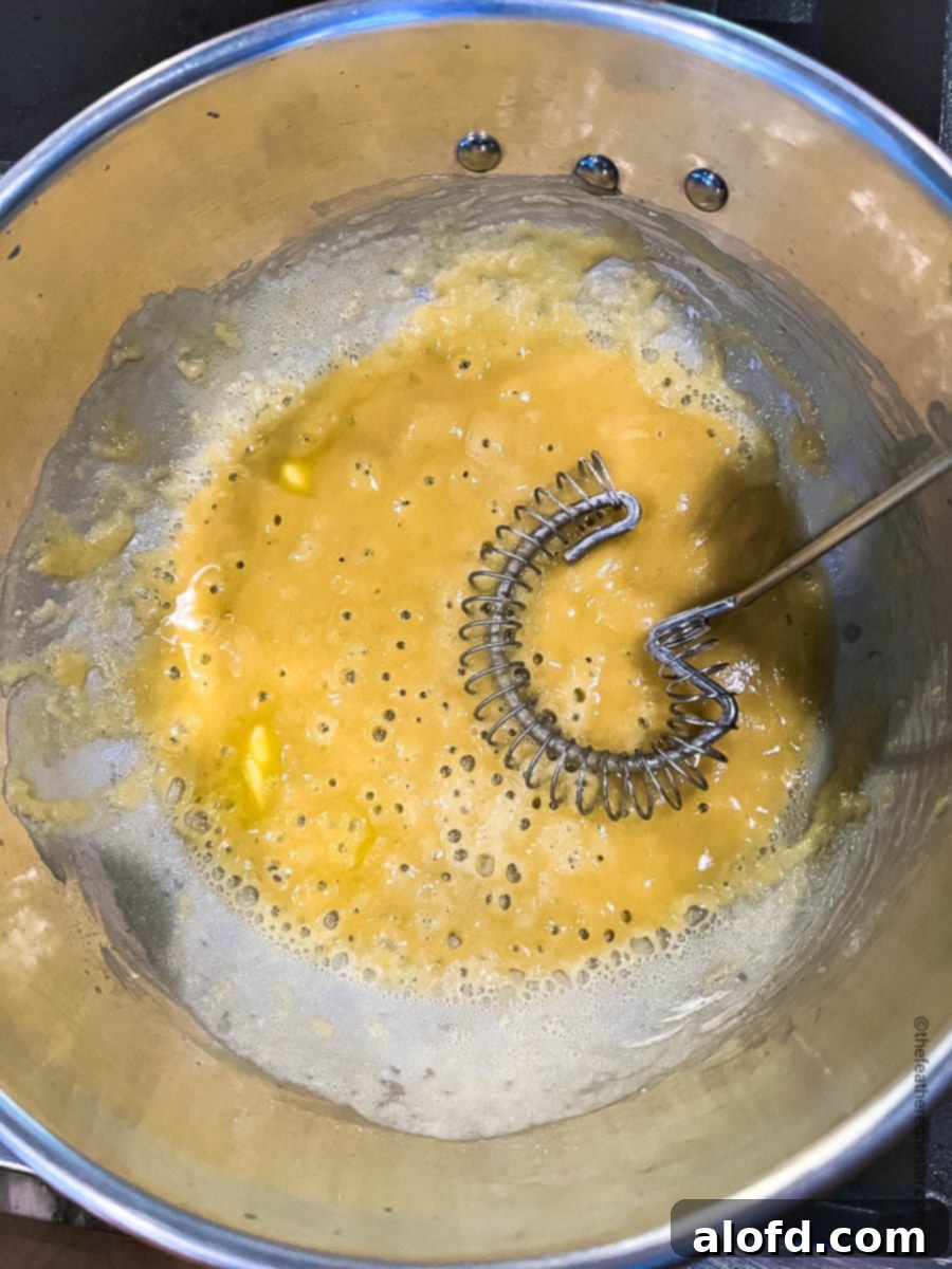 Velvety Cheese Béchamel 5 blonde roux in a saucepan.