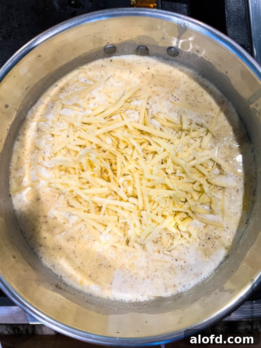 Velvety Cheese Béchamel 8 white cheese melting in a pot with bechamel.