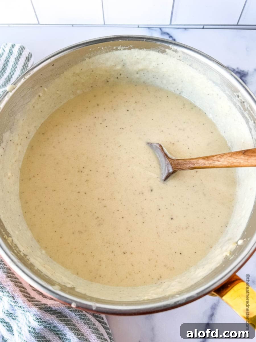 Velvety Cheese Béchamel 10 saucepan full of white cheddar cheese sauce.