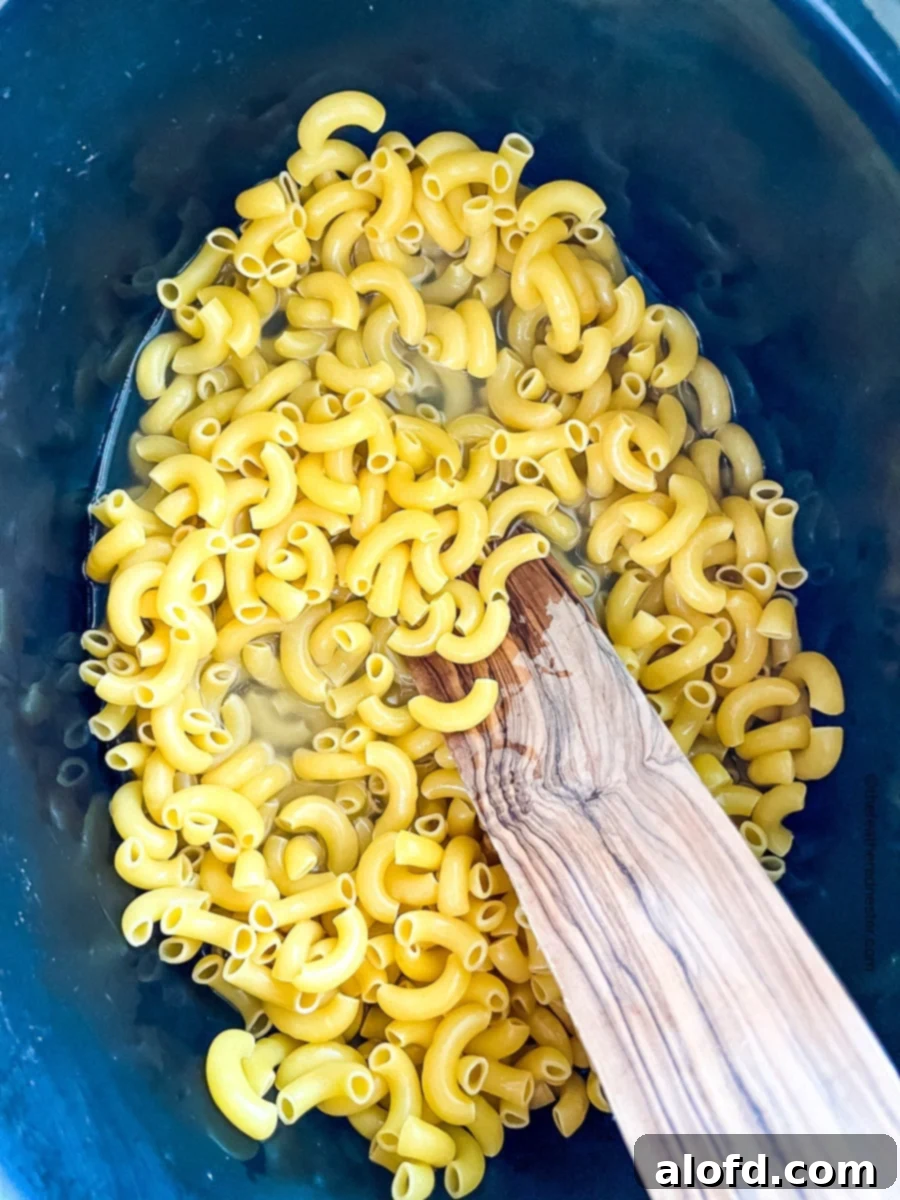 hot water and elbow macaroni in a slow cooker