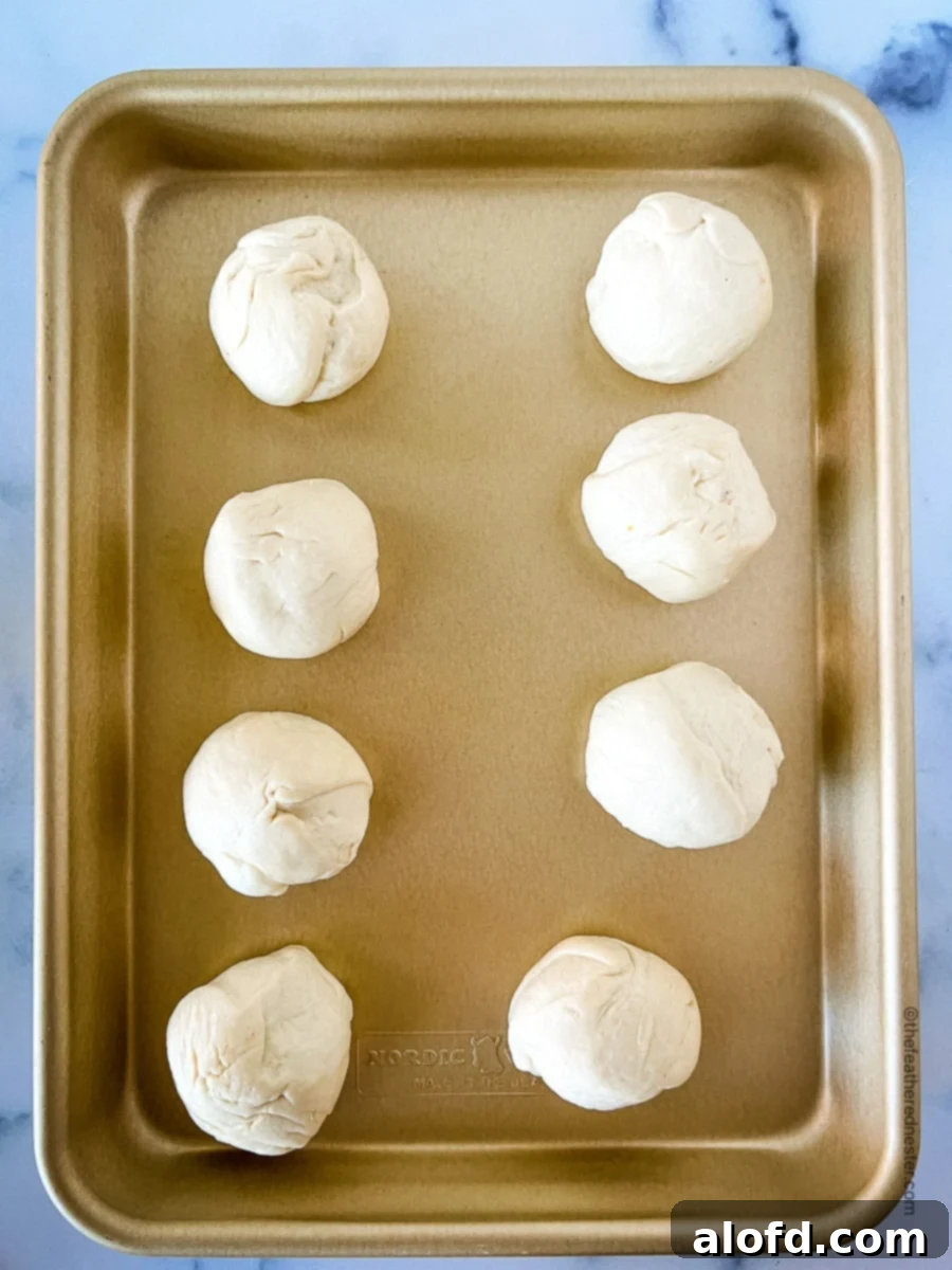 Savory Pepperoni Calzone Pockets 8 A baking sheet neatly arranged with 8 perfectly portioned dough balls, ready for shaping.