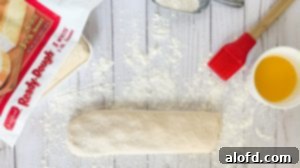 A roll of frozen bread dough, thawed and ready for preparation.