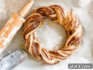 The pumpkin spice bread twist, rising, with a rolling pin and flour scoop nearby.