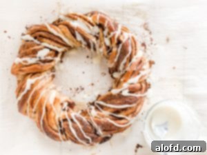 The finished pumpkin spice twist, beautifully glazed and resting on parchment paper.