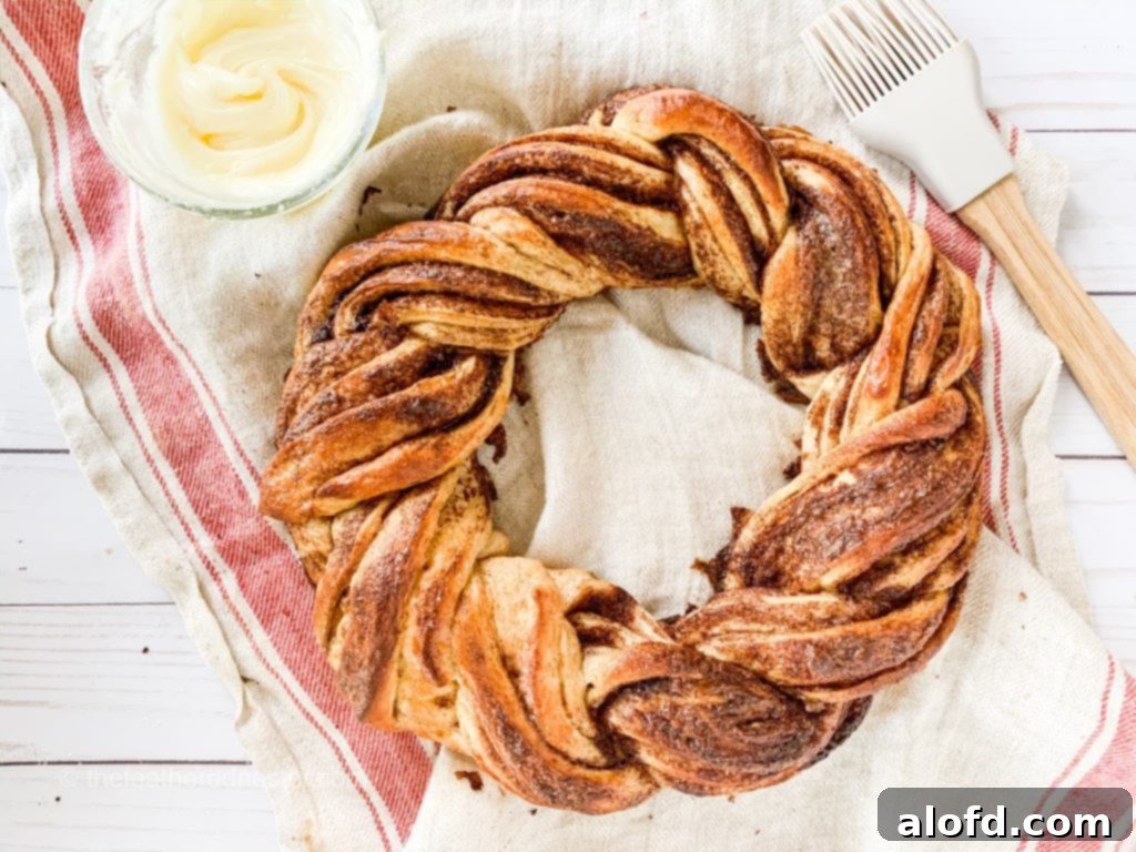 A freshly baked and glazed pumpkin spice bread twist wreath, ready to be served and enjoyed.