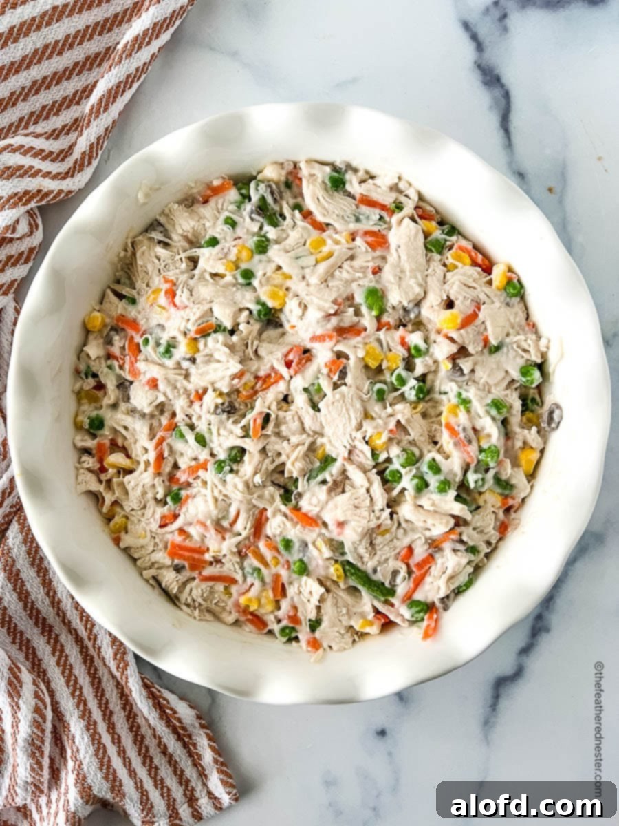 Easy Bisquick Chicken Pot Pie Bake 4 Pot pie filling in a round casserole dish.