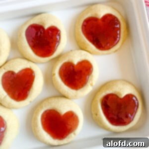 Cute heart jam cookies on a white platter.