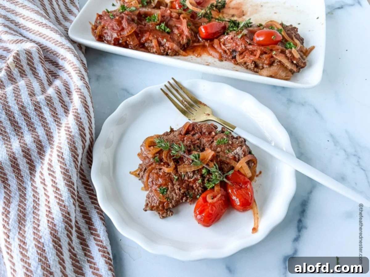 Tender Slow Cooker Swiss Steak 3 Crock Pot Swiss steak on a white plate and more on a serving platter at the back.