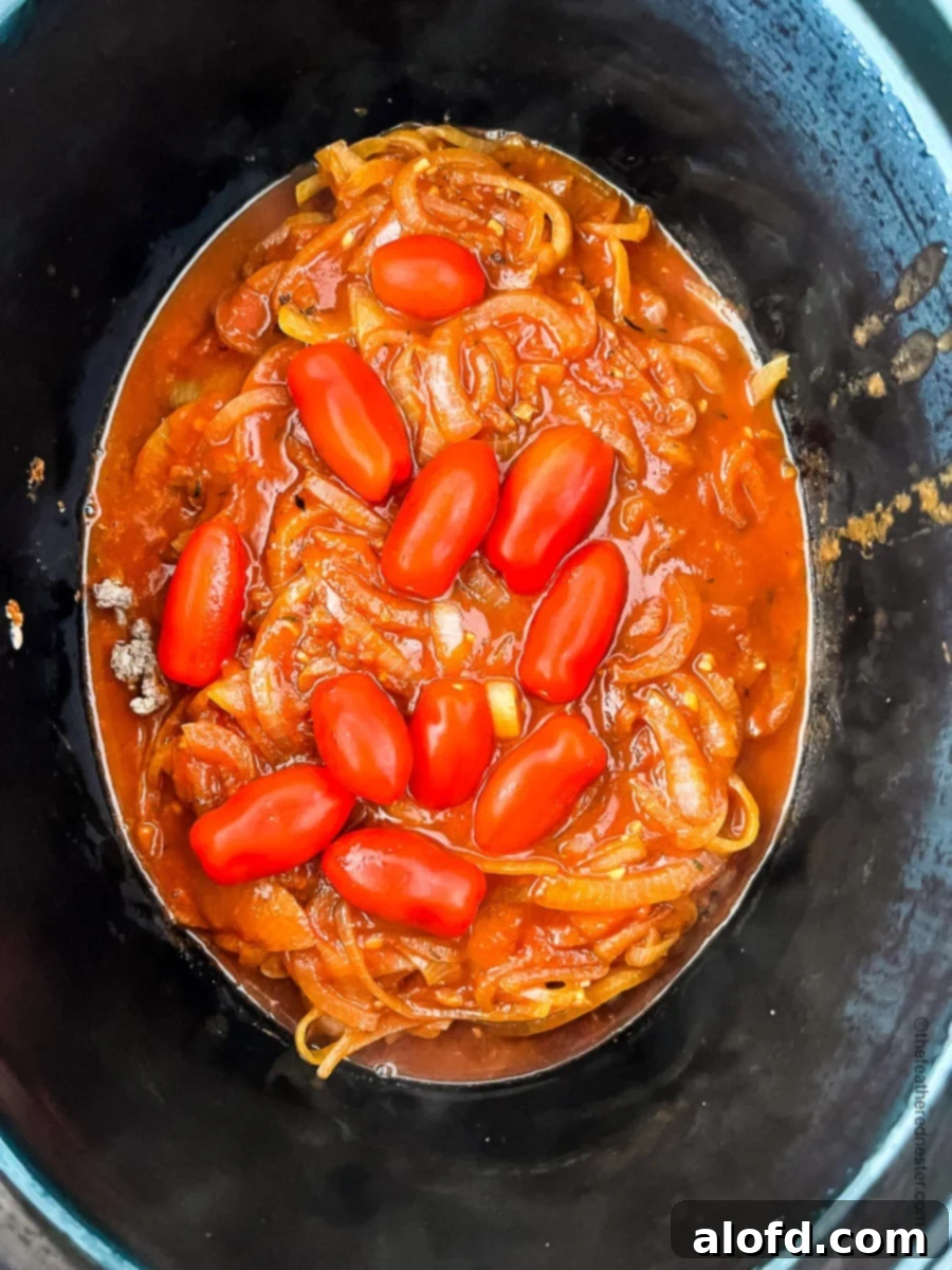 Tender Slow Cooker Swiss Steak 7 all the ingredients for crock pot swiss steak placed in slow cooker.