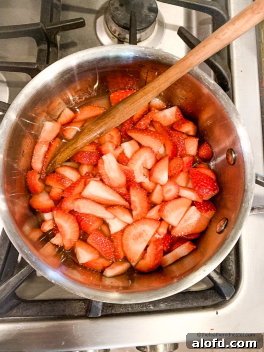 Luscious Strawberry French Toast 9 Strawberry syrup for French toast simmering in a saucepan.