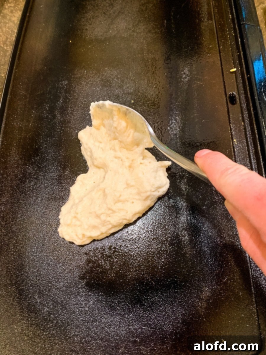 Shaping pancake into a heart shape.
