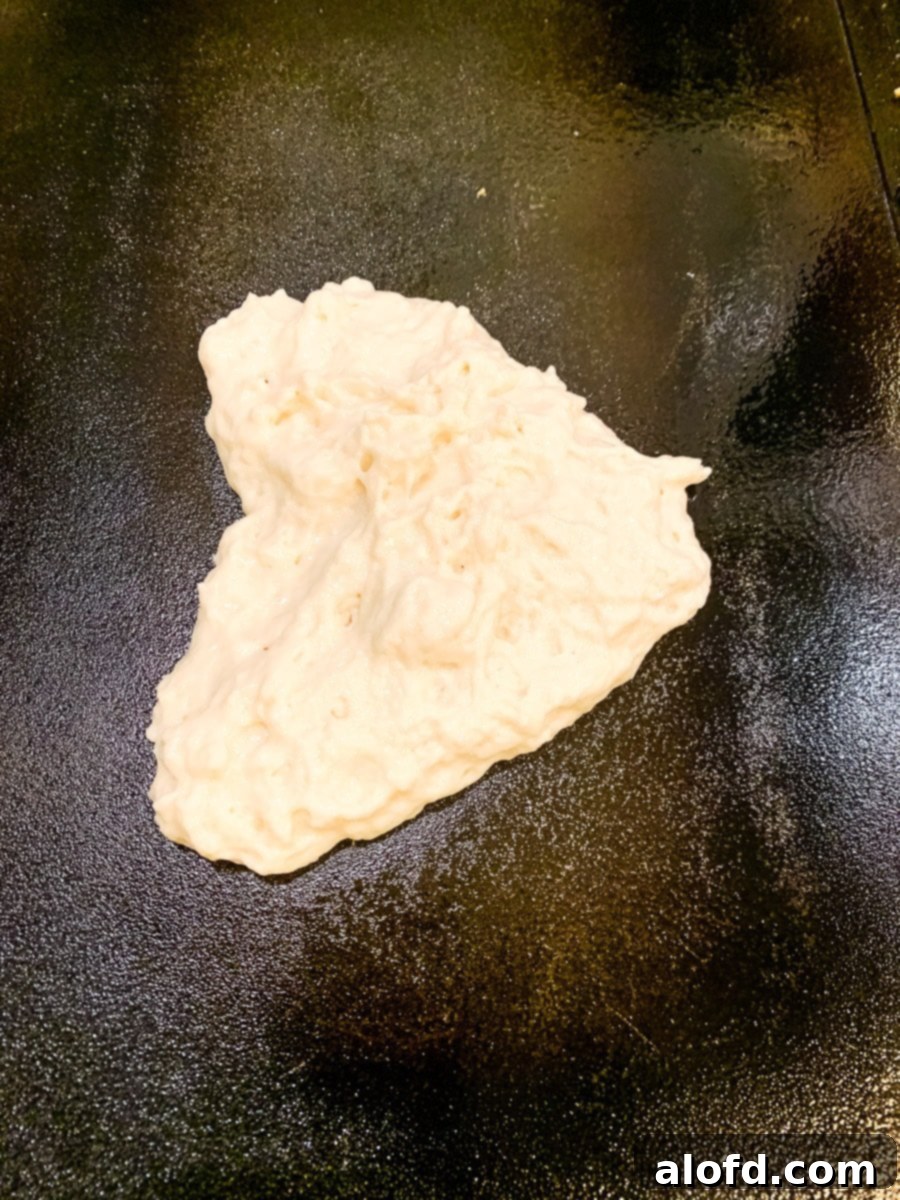 uncooked batter on a hot griddle.