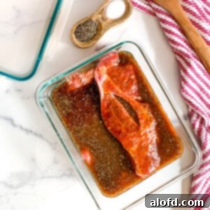 Pork chops in a dish of Asian marinade.