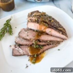 Fall-Apart Slow Cooker Sirloin Tip Roast 11 Slices of tip roast with gravy over the top.