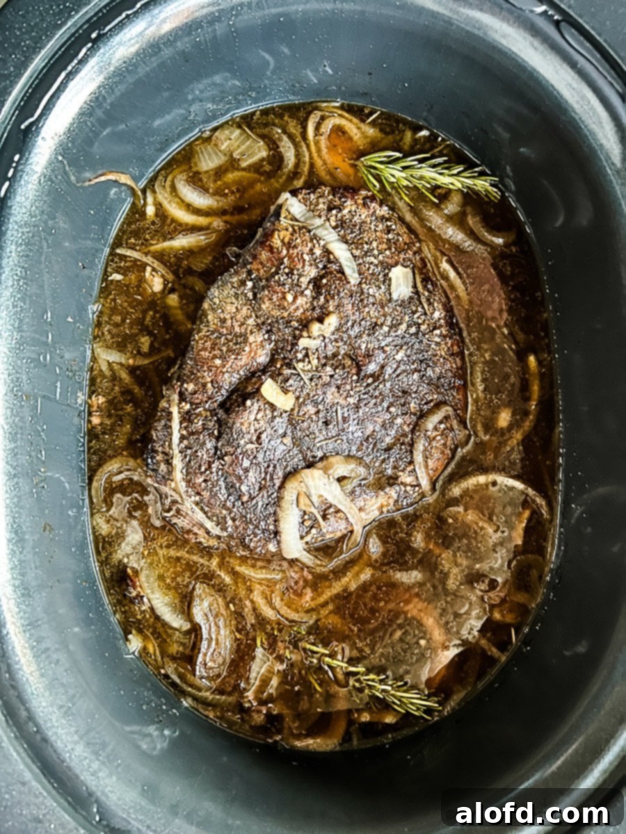 Fall-Apart Slow Cooker Sirloin Tip Roast 9 Slow cooked sirloin tip roast in crock pot with beef stock and onions.