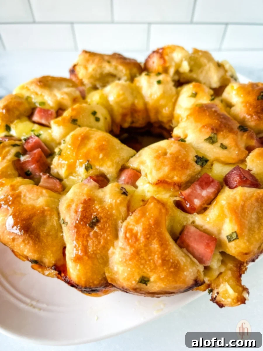 A plate of monkey bread with ham and brie.