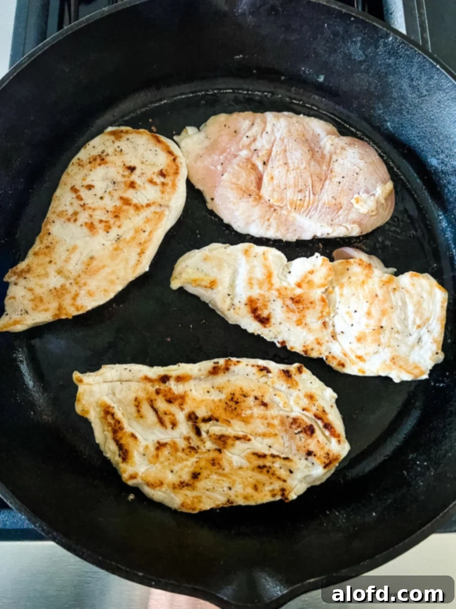 Perfectly Seared Cast Iron Chicken Breast 7 Making a skillet chicken recipe on stove.