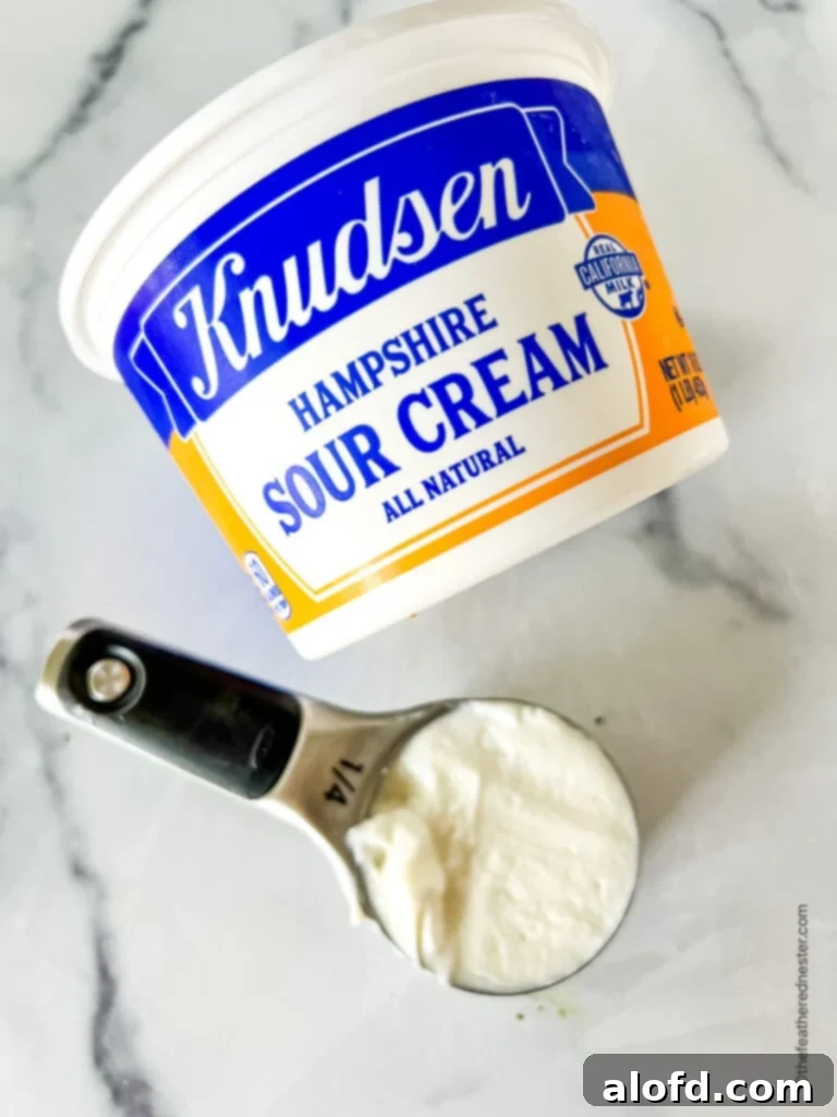 8 Simple Swaps for Egg-Free Cornbread 11 Measuring cup of sour cream next to the container.